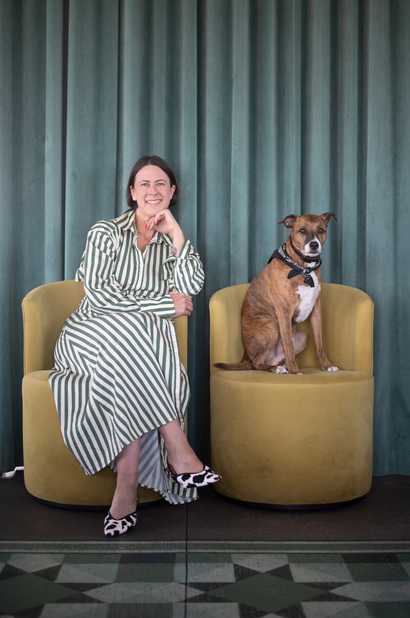Steph S., brand architect, seated beside a dog